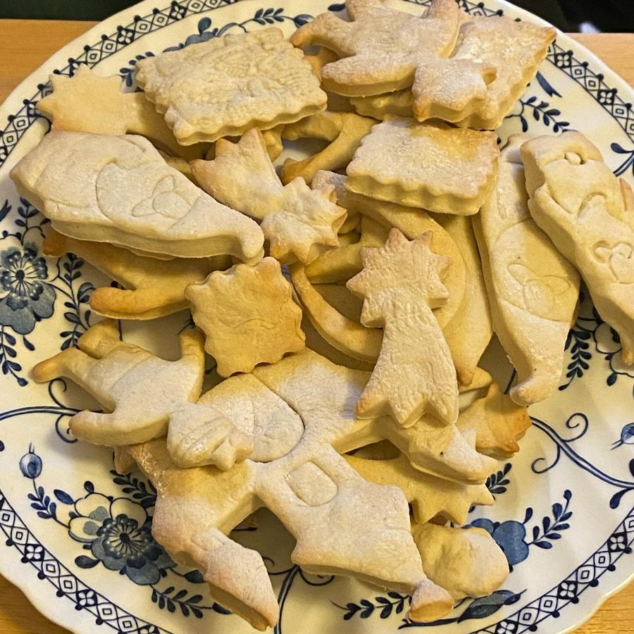 Homemade cookies in castle and star shapes on a blue-patterned plate