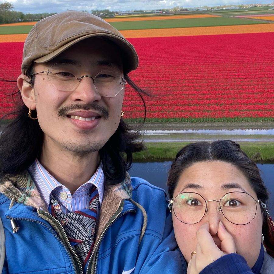 Ryo and Maria pulling faces in front of tulip fields